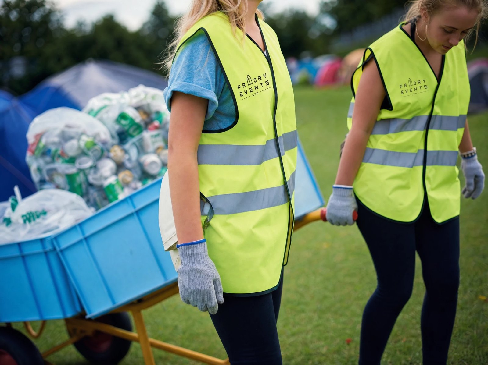 Priory Events crew in hi-vis clearing litter and recycling at a campsite