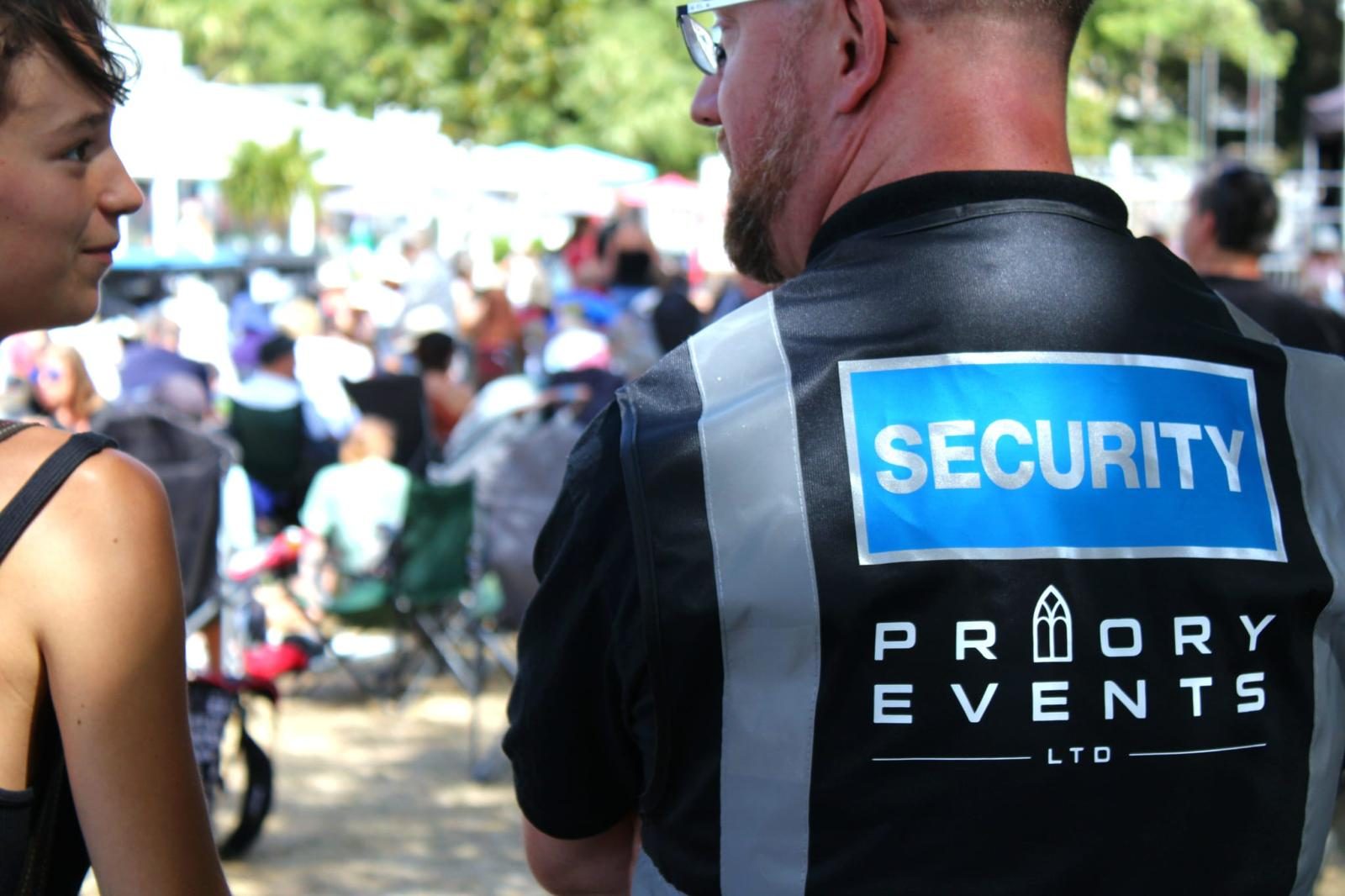 Priory Events crew member in a branded polo shirt at an outdoor event